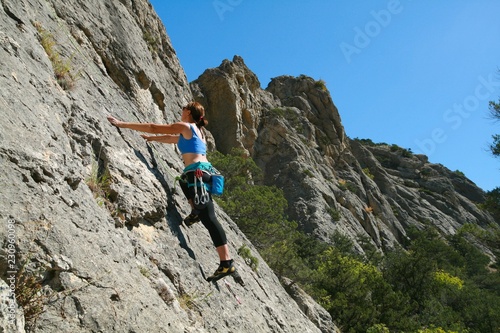 Young female climber on the rocks in the Crimea.