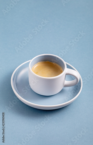Single black coffee cup on blue background