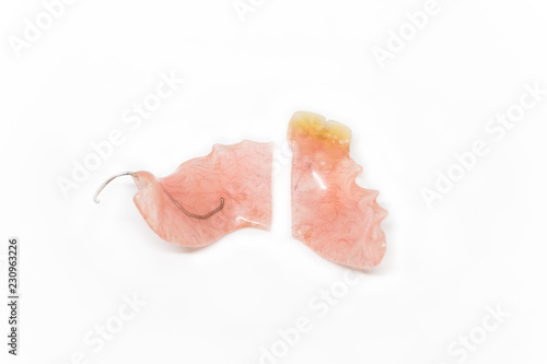 broken denture on white background