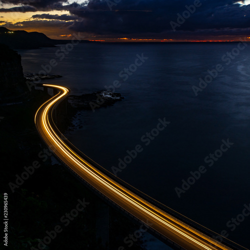 Light trail at the Sea Cliff Bridge, Australia. Morning glow pre sunrise.