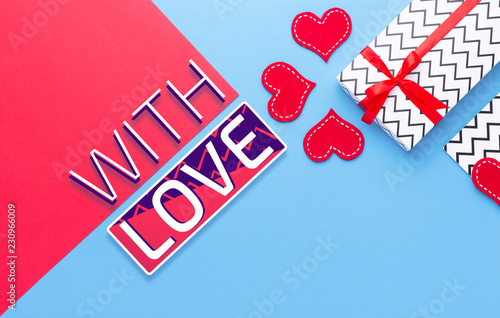 Person holding a present for Saint Valentine's day in his hands. Beautiful colorful background to st. Valentine day. Greeting card with red hearts. Wedding's invitation. Love expression.  photo