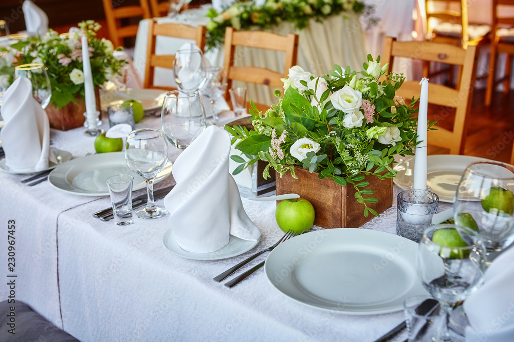 Simple and elegant table for a festive or wedding event, decorated in green and white