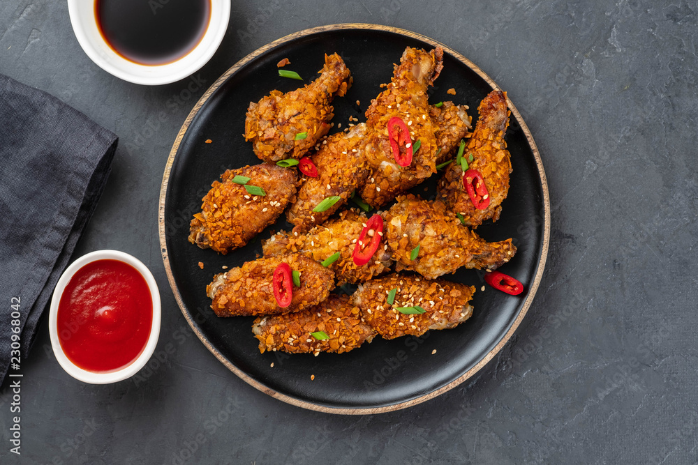Chicken nuggets with sauce and pepper on a dark background. Copy space. Chicken nuggets with sauce and pepper on a dark background. Copy space.