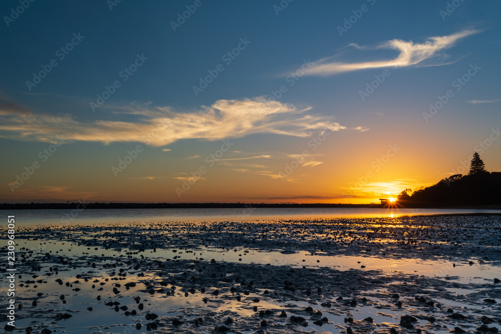 Sunset over Harrington Lagoon, Australia. Cloud reflections on a still day on New South Wales mid north coast.