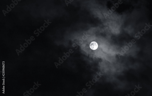 Full moon with dark clouds in the night sky