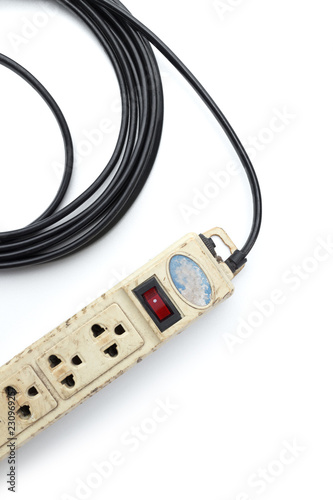 Old and unsafe power strip with illuminated switch isolated on white background