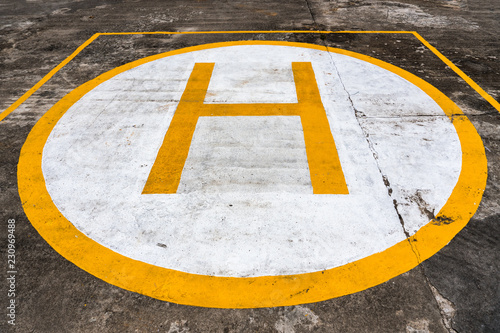 Sign on Concrete surface. Helipad for helicopter landing