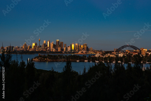 Blue hour sunrise over Sydney Harbour. City skyline taken from Taronga Zoo. © Craig Milsography