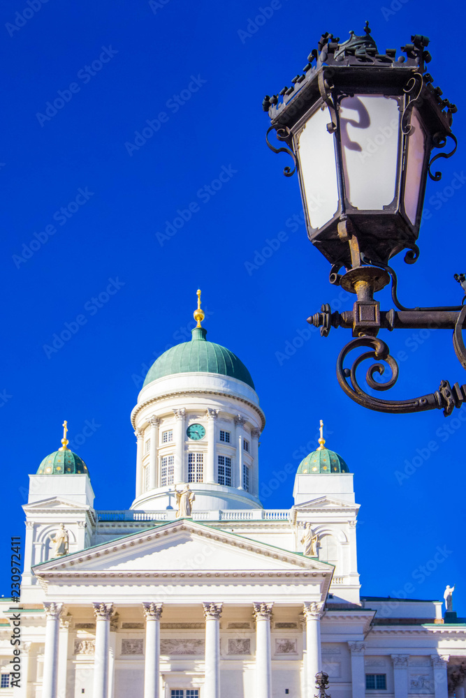 Element of street lamp and dome of Helsinki Cathedral (St Nicholas' Church) on Senate Square, Helsinki, Finland