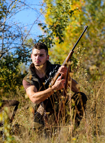 Hunter with rifle ready to hunting nature background. Hunting skills and strategy. Hunting strategy or method for locating targeting and killing targeted animal. Man hunting wait for animal