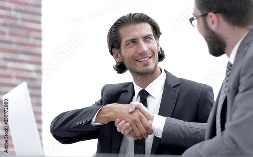 confident handshake colleagues in the office photo