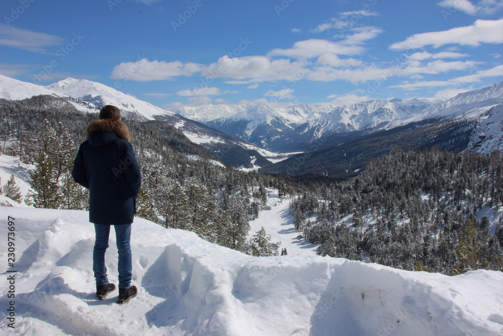 Man watching Swiss National Park in wintertime, Switzerland