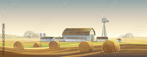 Autumn rural landscape with hay bale, and farm on the back plan.