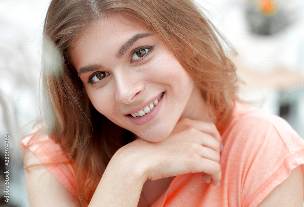 portrait of young smiling woman in the background of the living room. portrait of young smiling woman in the background of the living room.