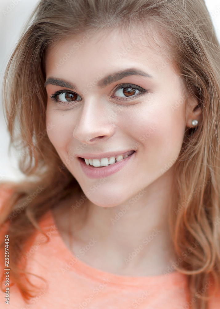 closeup portrait of a young woman on blurred background. closeup portrait of a young woman on blurred background.