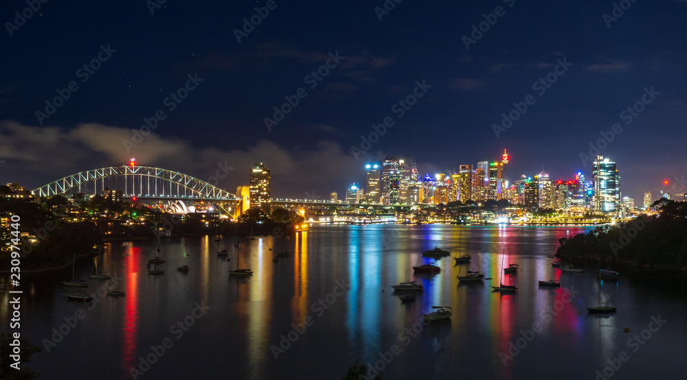 Sydney cityscape with reflections off Sydney Harbour. Night view off Sydney city.