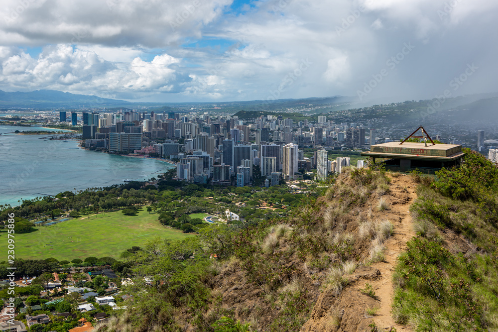 Fototapeta premium The Diamond Head war bunkers and the iconic Waikiki Beach in the background from the Diamond Head Volcano Walk on a sunny day at Waikiki Honolulu Hawaii on the 8th of October 2018