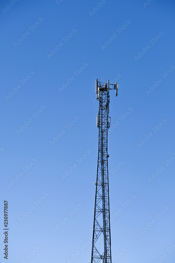 Cellular Base Station Tower and Clean Blue Sky. Telecommunication tower. Wireless Communication Antenna Transmitter. 3G, 4G and 5G Cell Site
