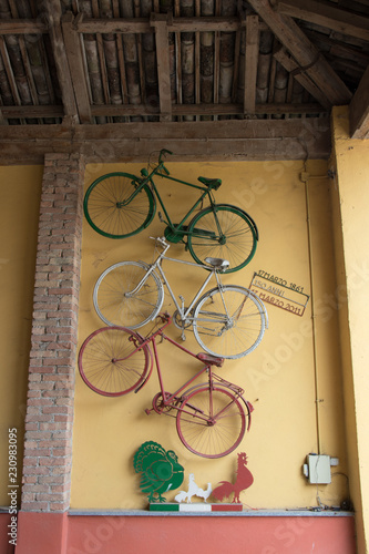 Bikes hanging on the wall in Italian flag colors