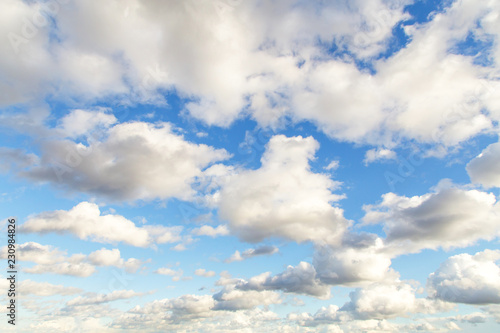 Blue sky with white cumulus fluffy clouds background 
