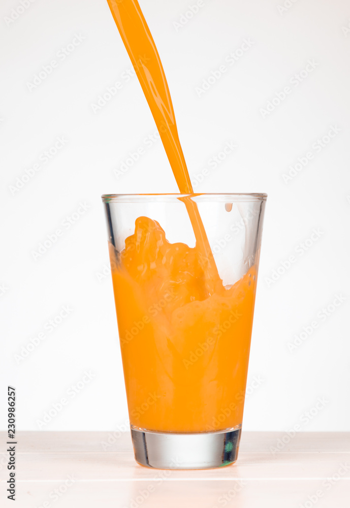 © Nicole Lienemann - pour multivitamin juice in a glass with splashing © Nicole Lienemann - pour multivitamin juice in a glass with splashing