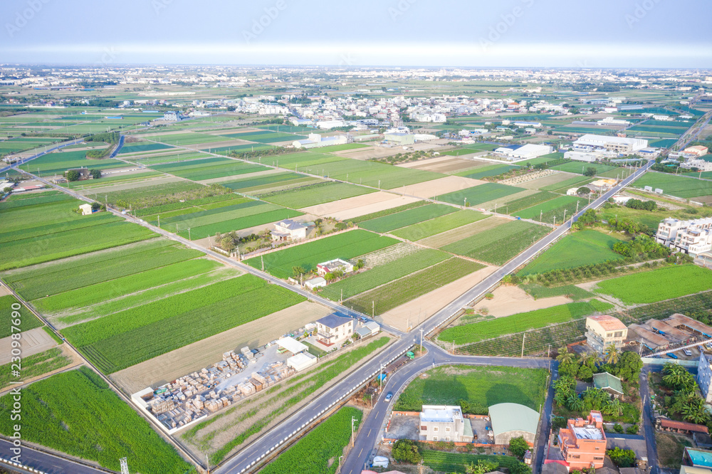 Fields with various types of agriculture and villages beside with air pollution in winter morning, Tainan, Taiwan, aerial view