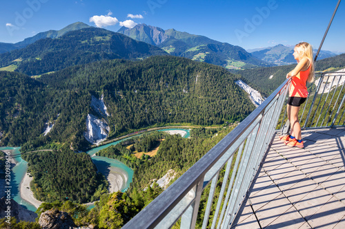 Young girl looks over the river from Il Spir terrace, Rhine Gorge (Ruinaulta), Flims, District of Imboden, Canton of Grisons (Graubunden) photo