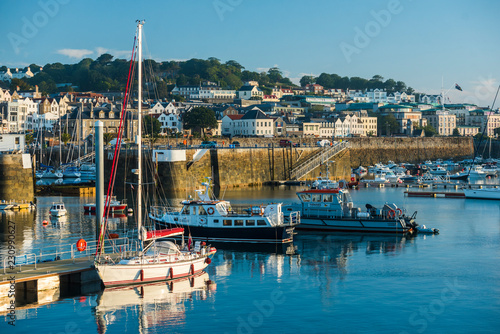 Boats in St. Peter Port Harbour at sunrise, Guernsey, Channel Islands photo