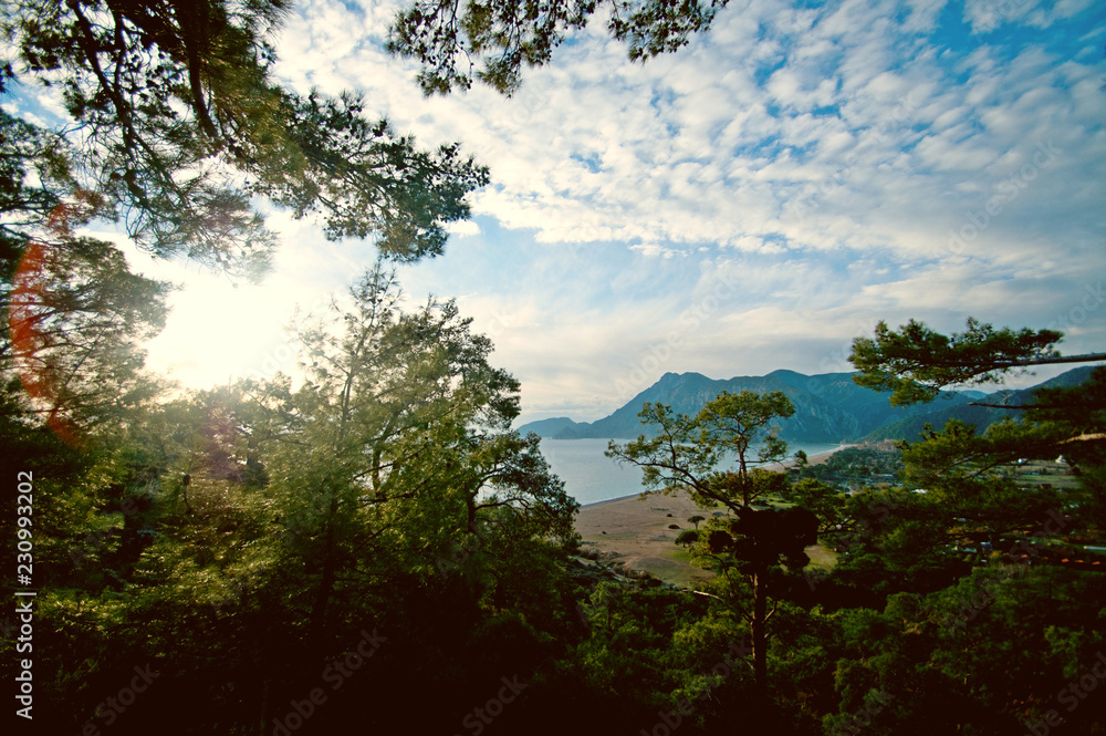 Scenic view of the mountains, sea and forest taken on a bright sunny day Scenic view of the mountains, sea and forest taken on a bright sunny day
