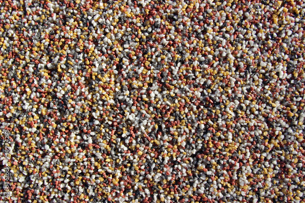 Red, yellow, white and grey gravel wall decoration surface texture close up