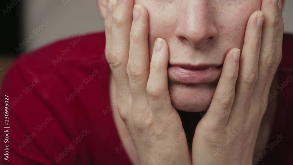 The camera tilts up to reveal the face of a bored woman staring into the camera. The camera tilts up to reveal the face of a bored woman staring into the camera.