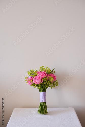 Fototapeta Naklejka Na Ścianę i Meble -  bridal bouquet of fresh roses on the table. wedding floristry, floristic decorative statement