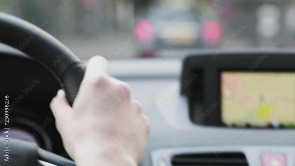 Woman drives a car with navigation in a city, closeup footage. Woman drives a car with navigation in a city, closeup footage.