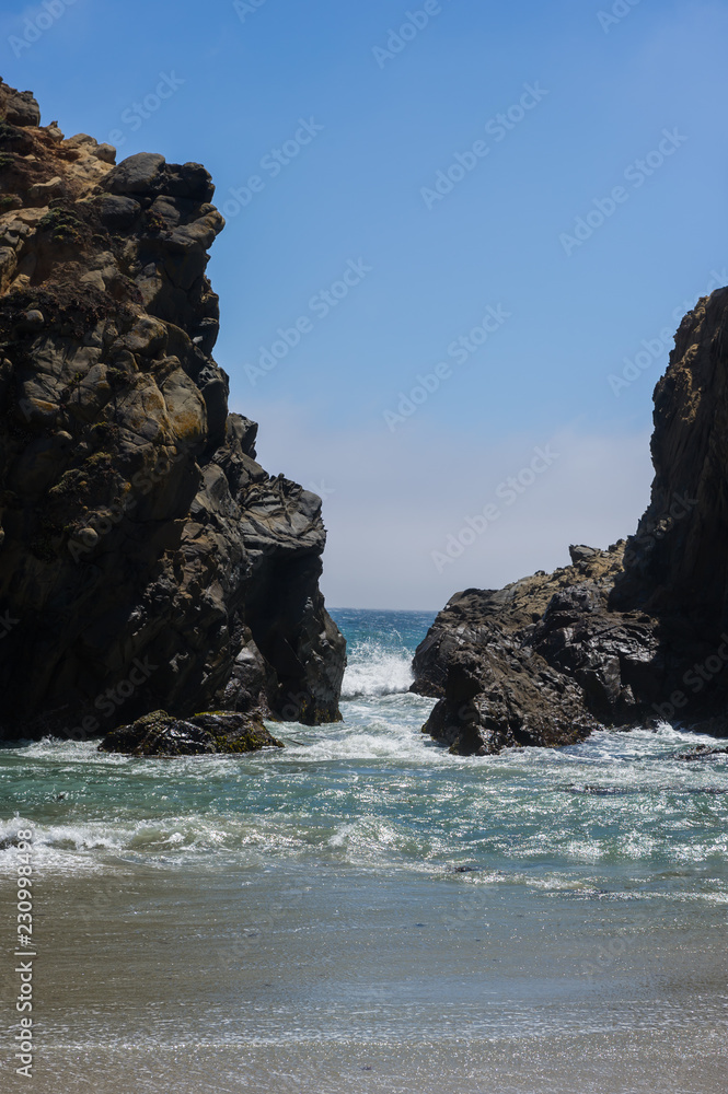 Big stone with gap at ocean beach California. Big stone with gap at ocean beach California.