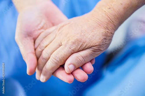 Holding Touching hands Asian senior or elderly old lady woman patient with love, care, helping, encourage and empathy at nursing hospital ward : healthy strong medical concept 