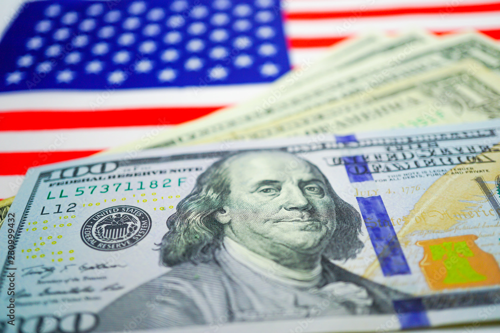 US dollar banknotes on US Flag. Business and finance concept. US dollar banknotes on US Flag. Business and finance concept.