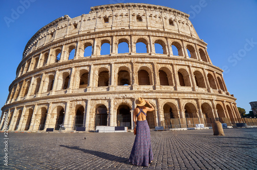 Colosseum and young tourist woman near gladiator arena famous ancient historical roman empire architecture landmark stone ruin amphitheater monument
