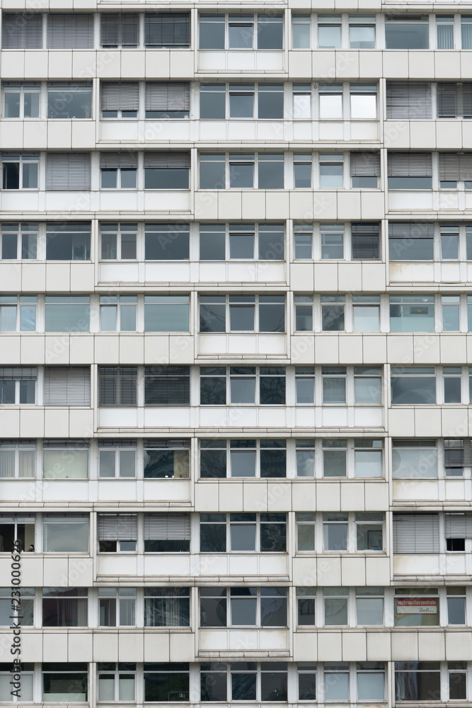 White and grey uniform facade of old apartment block, Berlin, Germany White and grey uniform facade of old apartment block, Berlin, Germany