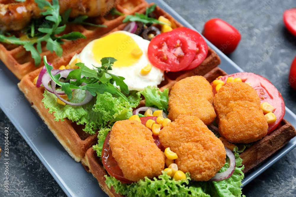 Delicious waffles with chicken and fried egg on plate Delicious waffles with chicken and fried egg on plate