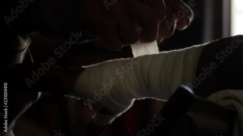 Boxer getting hand wrap by trainer in slow-motion