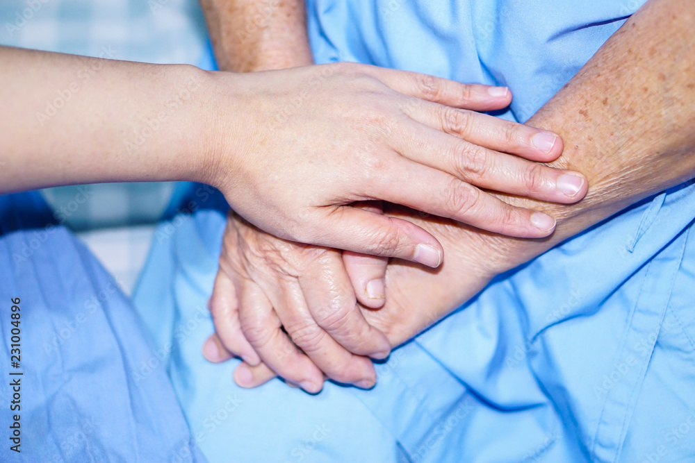 Touching hands Asian senior or elderly old lady woman patient with love, care, helping, encourage and empathy at nursing hospital ward : healthy strong medical concept Touching hands Asian senior or elderly old lady woman patient with love, care, helping, encourage and empathy at nursing hospital ward : healthy strong medical concept