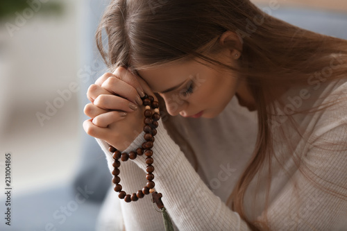 Bild auf Leinwand Beautiful young woman praying at home