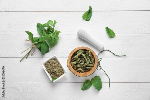 Composition with dried mint on white wooden background, top view