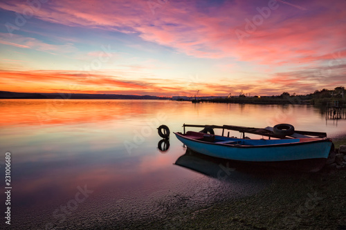 exciting sunset / sunrise on a seashore with boat
