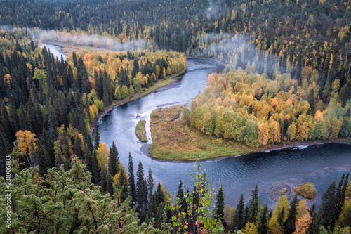 Scenic river landscape with fall colors woodland at autumn morning in National Park, Finland