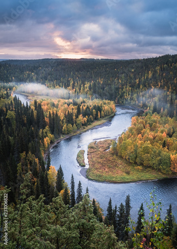 Scenic river landscape with fall colors woodland at autumn morning in National Park, Finland