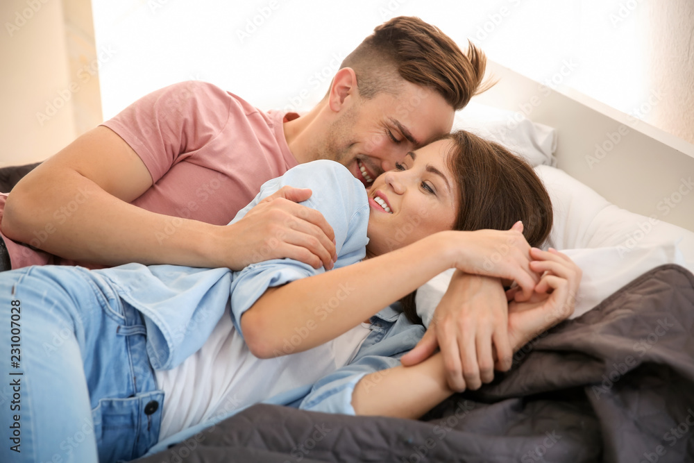 Fototapeta premium Loving couple relaxing on bed