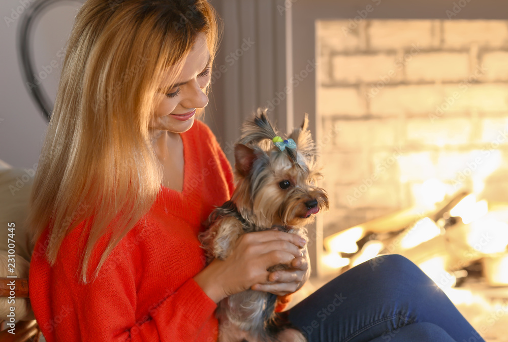 Woman with cute dog resting near fireplace Woman with cute dog resting near fireplace
