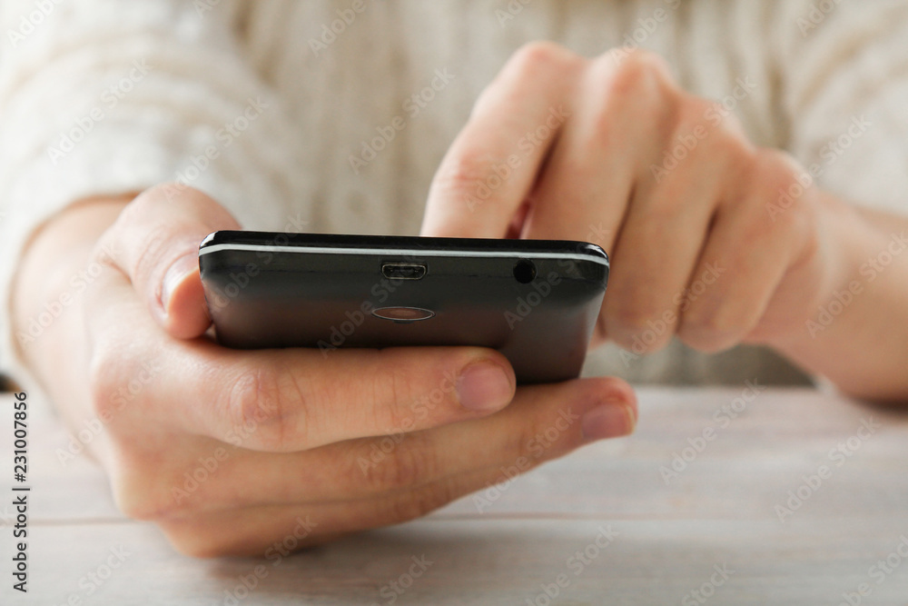 Black smartphone in hand Black smartphone in hand
