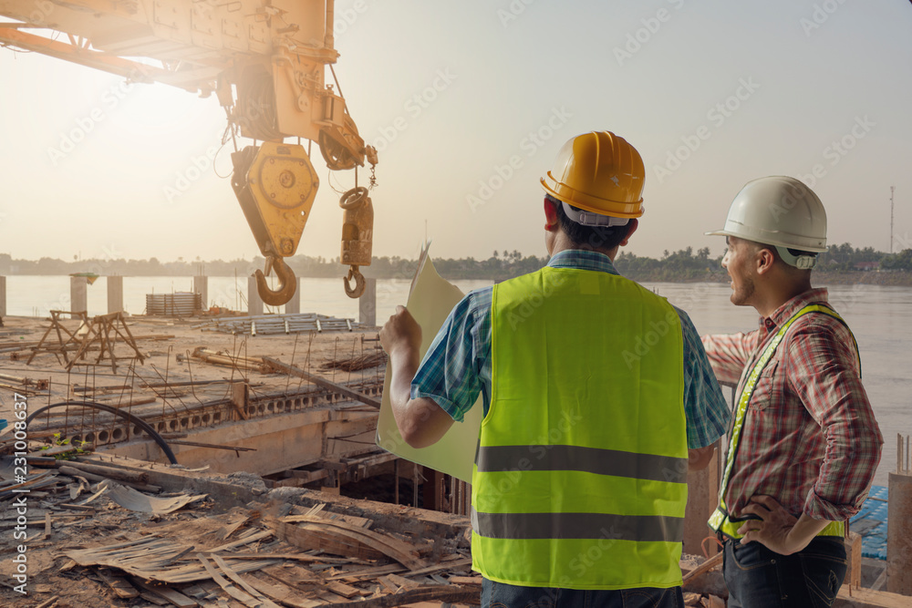 Construction engineers discussion with architects at construction site or building site. Construction engineers discussion with architects at construction site or building site.